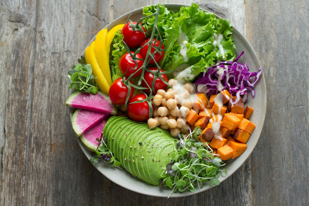 Colorful nutrient-dense whole foods arranged on a table, representing a functional nutrition approach to eating